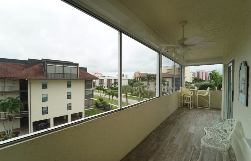 Large lanai with Pub table and chairs, new outdoor fans and new tile floors 