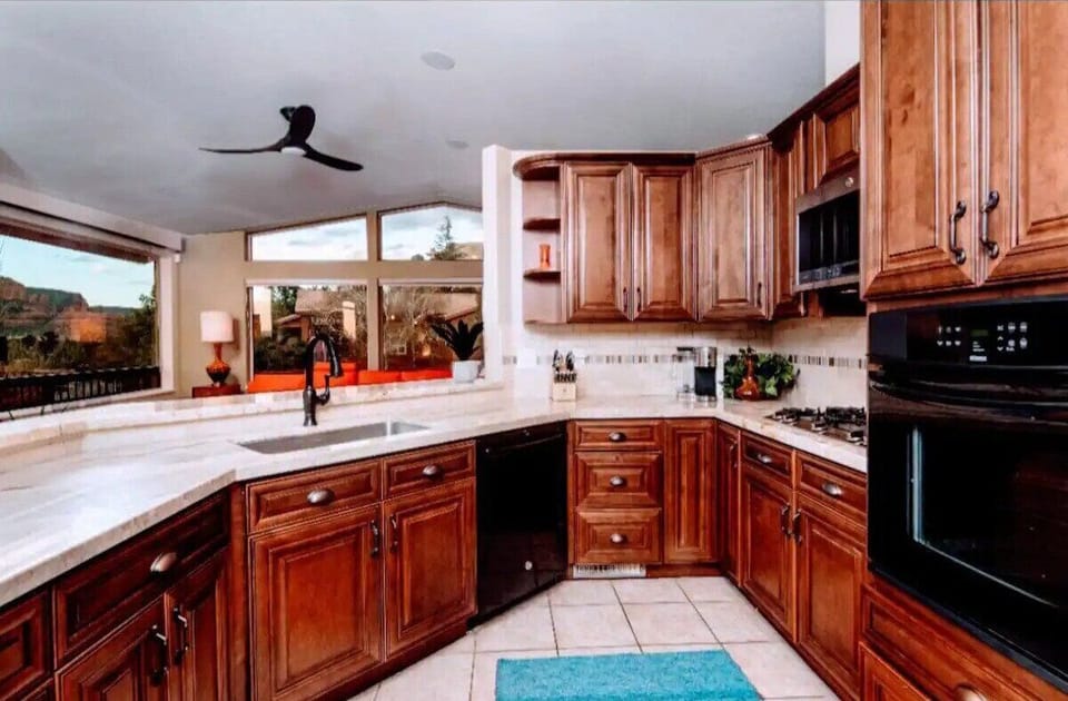 Kitchen with gas stove and granite countertops 
