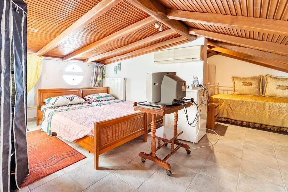 Our 4th bedroom in the attic where 3 or 4 people can be accomodated in case more than 6 people visit us. The whole space is of 85 sq.metres net. Also, in this room behind the single beds there is a big balcony of amazing sea and Nature view, with garden furniture.