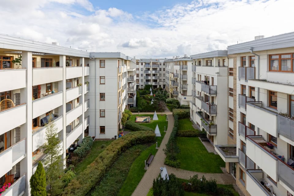 A stunning view of the apartment courtyard, featuring green landscaping and modern architecture.
