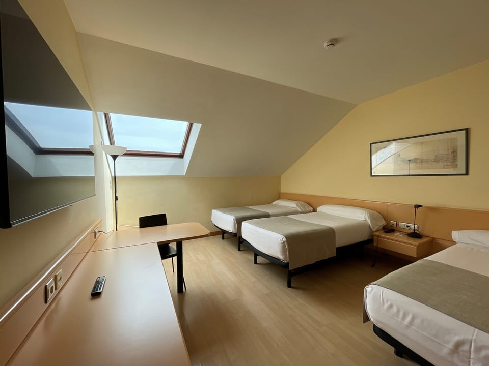 Triple Room (2 adults and 1 child) | Minibar, in-room safe, desk, blackout drapes