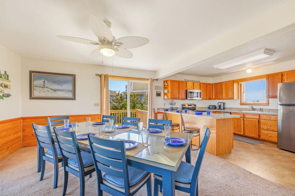 Gather around the spacious dining table for meals together, with a fully-equipped kitchen at your fingertips and coastal breezes from the open windows welcoming you to relax.