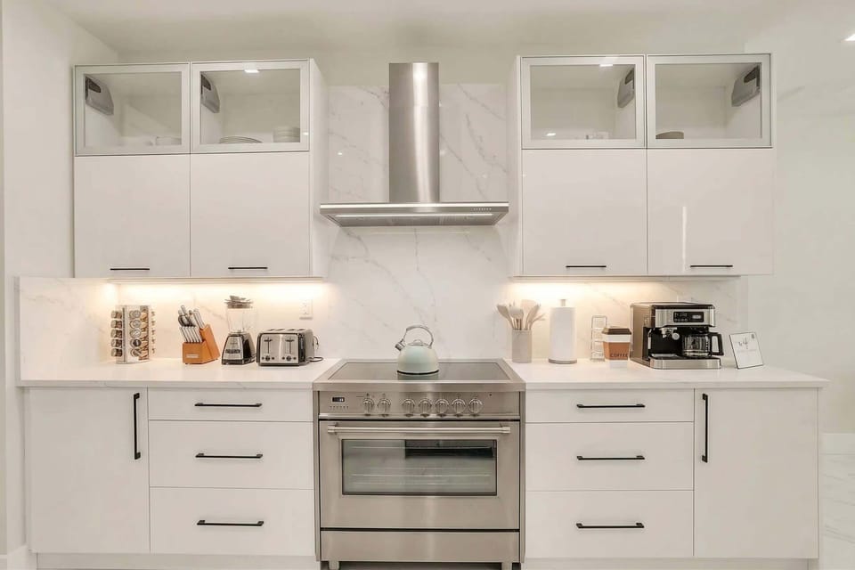 Cook with ease in the designer chef’s kitchen, fully appointed with modern appliances, sleek cabinetry, and everything needed for effortless gourmet dining.