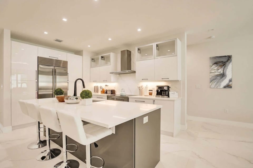 The sleek gourmet kitchen features premium finishes, spacious countertops, and a stylish island perfect for morning coffee or evening cocktails.