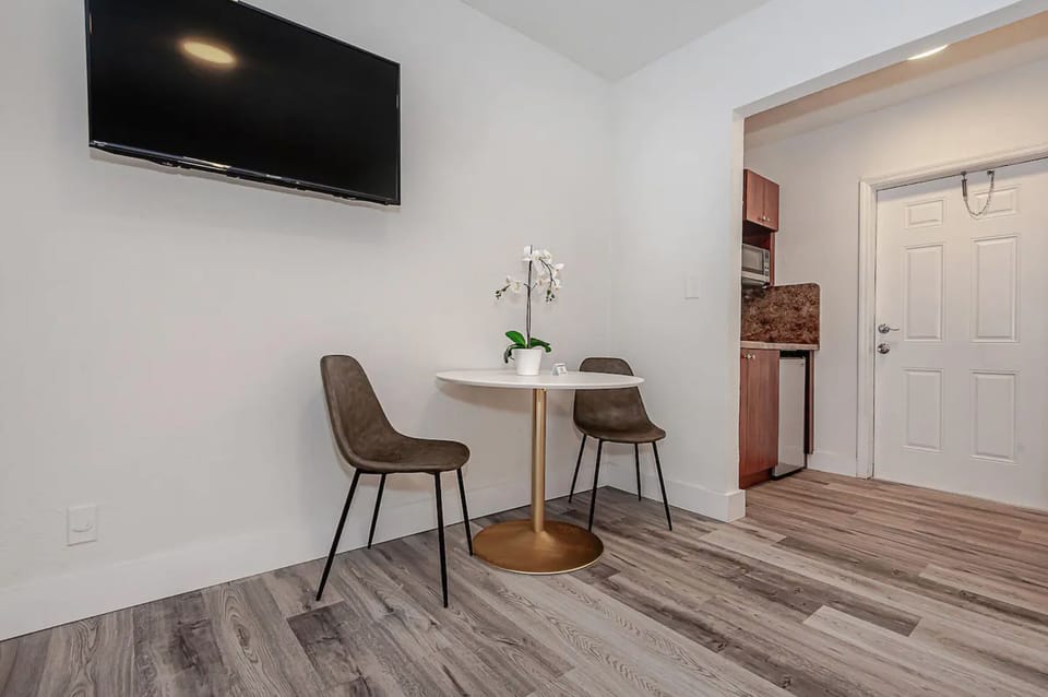 Featuring dining set and smart TV. Plush dining chairs with ottomans will be added by November 1st.