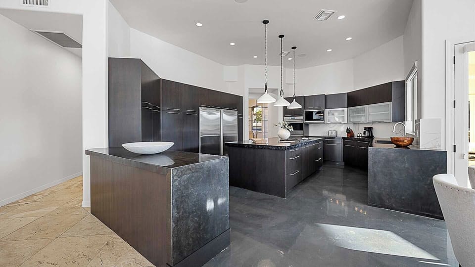 Spacious kitchen with sleek black cabinets & oversized island.