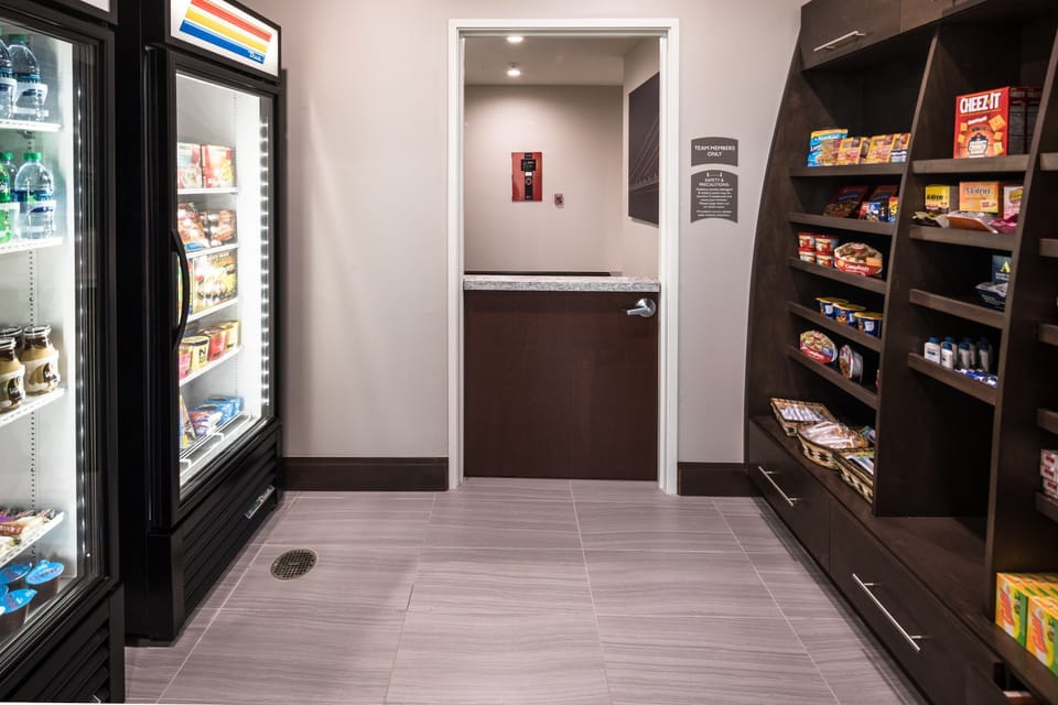 On-site pantry stocked with refrigerated items and snacks.