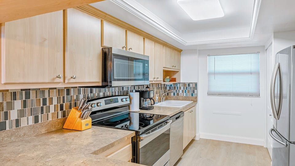 Fully equipped kitchen with modern appliances and backsplash