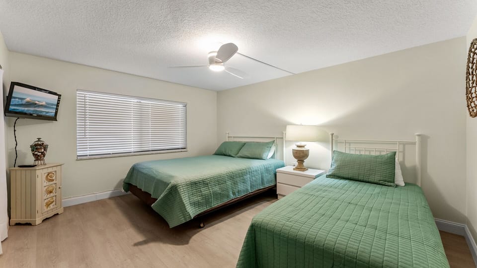 Comfortable guest bedroom featuring one queen bed and one twin bed