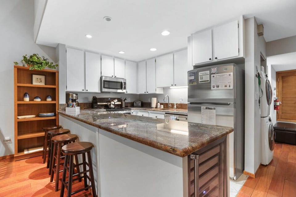 Culinary Dream: A well-appointed kitchen with sleek stainless steel fixtures and a dedicated wine fridge.