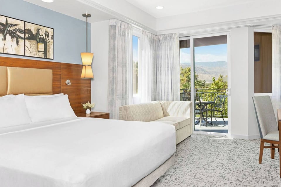 Guest bedroom features a king bed and sleeper sofa.