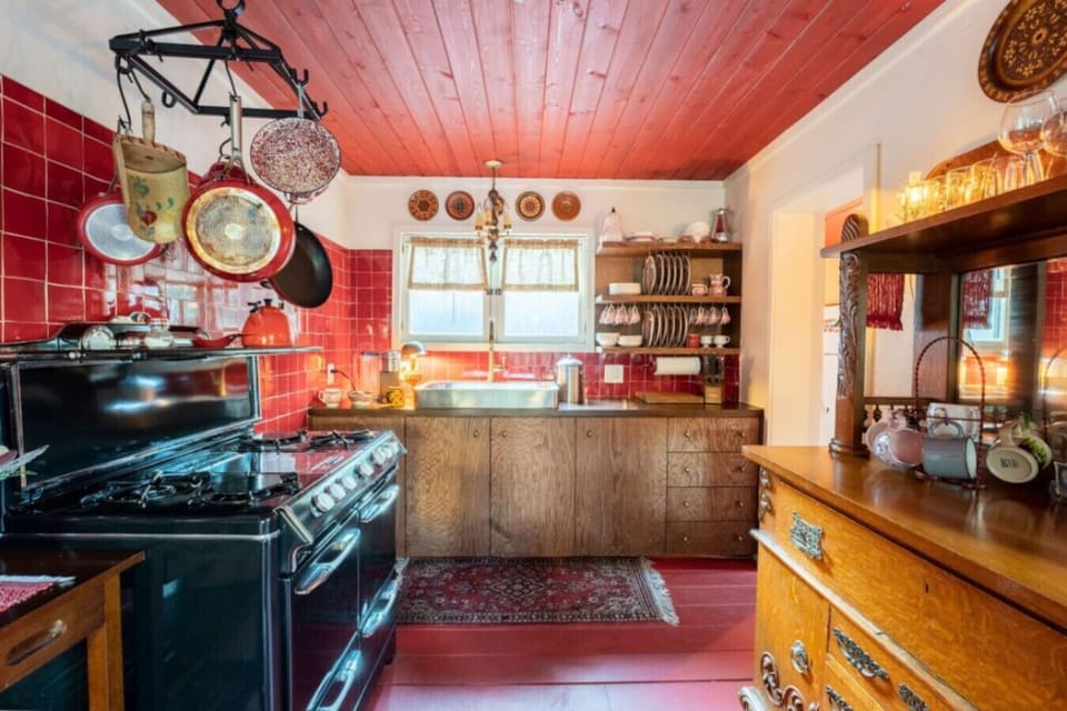 Cook in our cozy kitchen featuring a unique vintage stove
