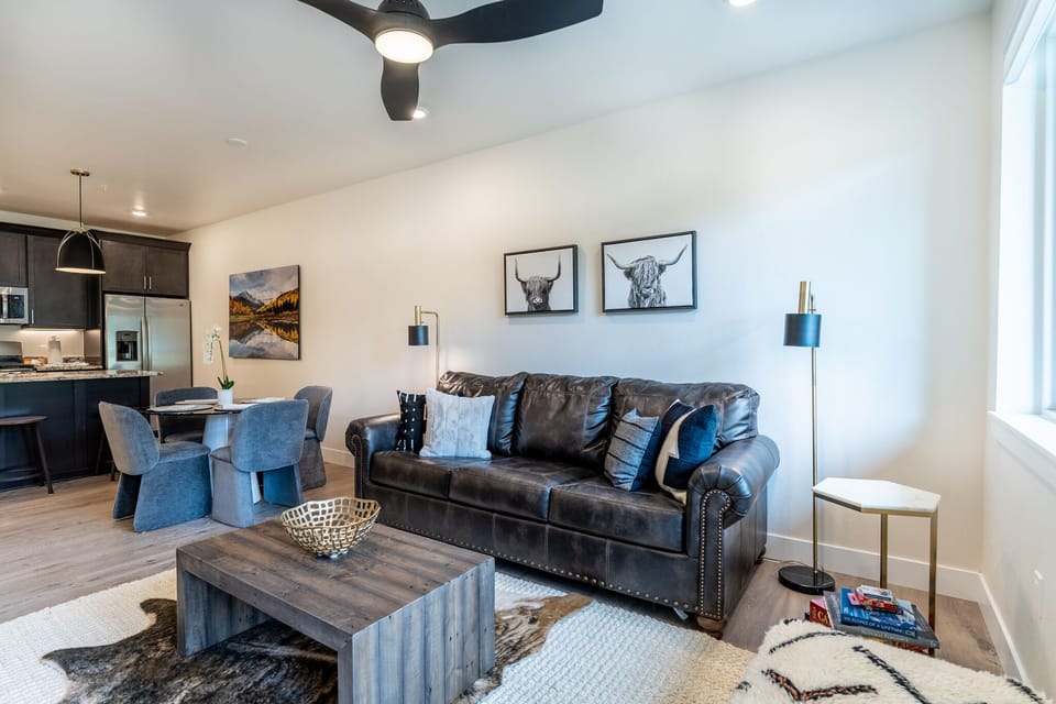 Relax in your stylish living space with plush leather seating, modern decor, and an open floor plan that flows seamlessly into the kitchen.