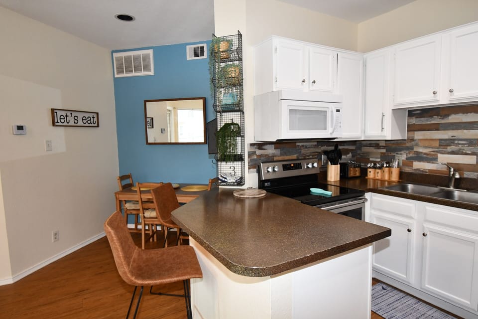Your fully equipped kitchen invites culinary adventures with modern appliances, granite counters, and cheerful dining space where memories are made.