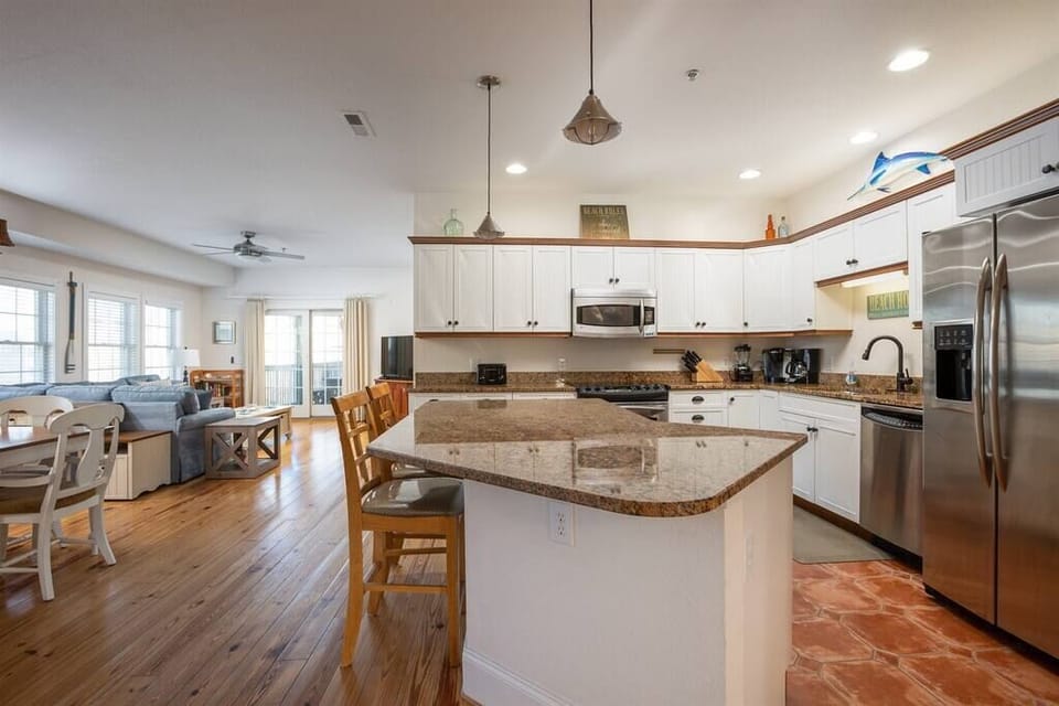 Modern Kitchen with Breakfast Bar seating for 2 and has dishwasher, fridge, oven, microwave, toaster, Keurig & drip, blender, and more