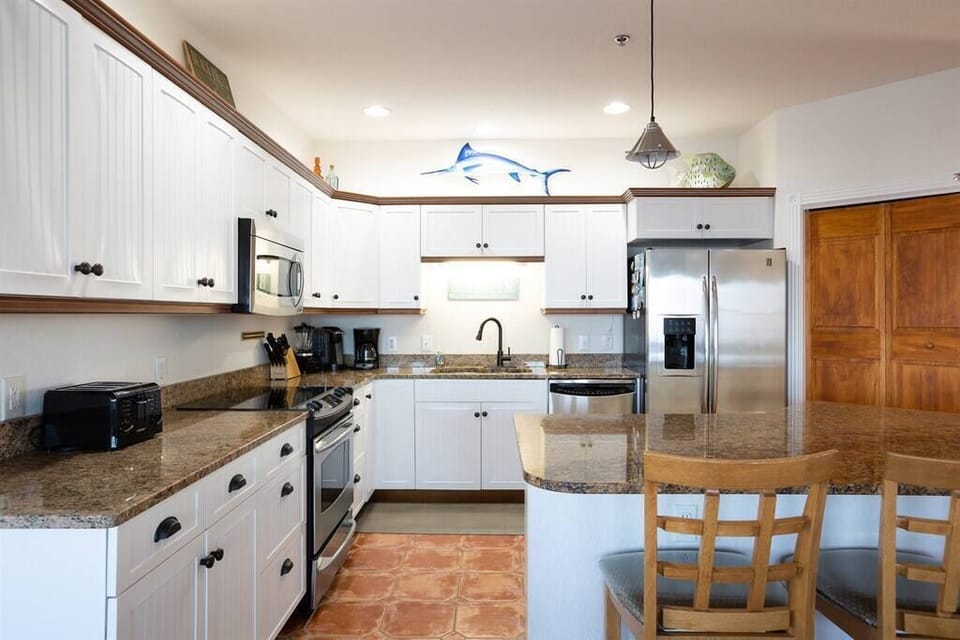 Modern Kitchen with Breakfast Bar seating for 2 and has dishwasher, fridge, oven, microwave, toaster, Keurig & drip, blender, and more