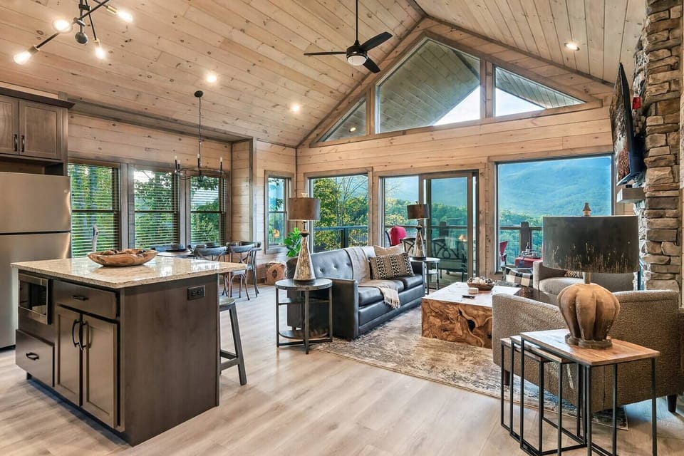 Open concept home with view of kitchen, living room, dining room, and view of mountains from entrance