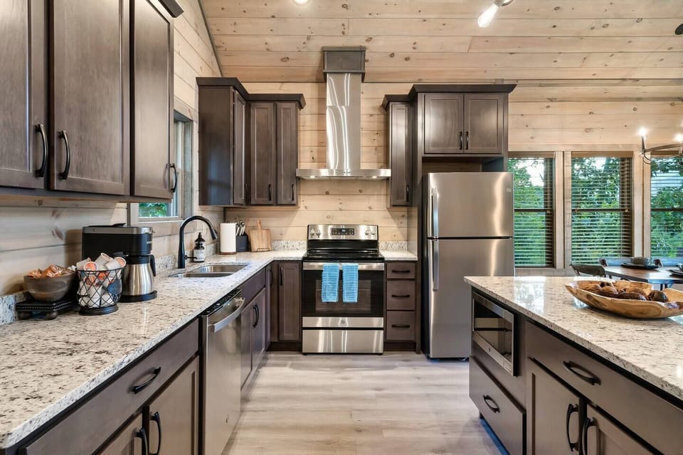 Fully stocked stainless kitchen appliances with granite counters