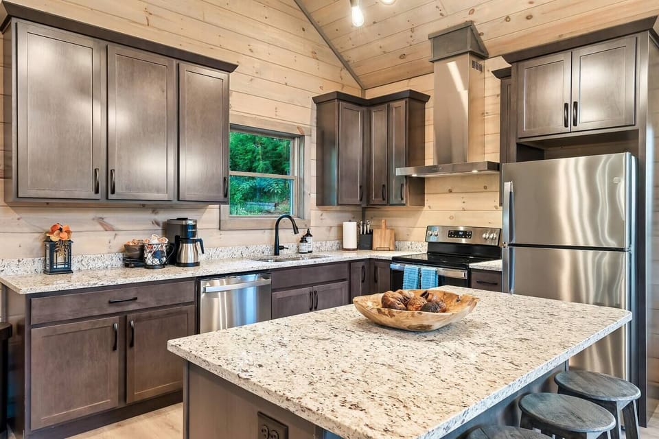 Kitchen with large island. Barstools are provided for extra seating