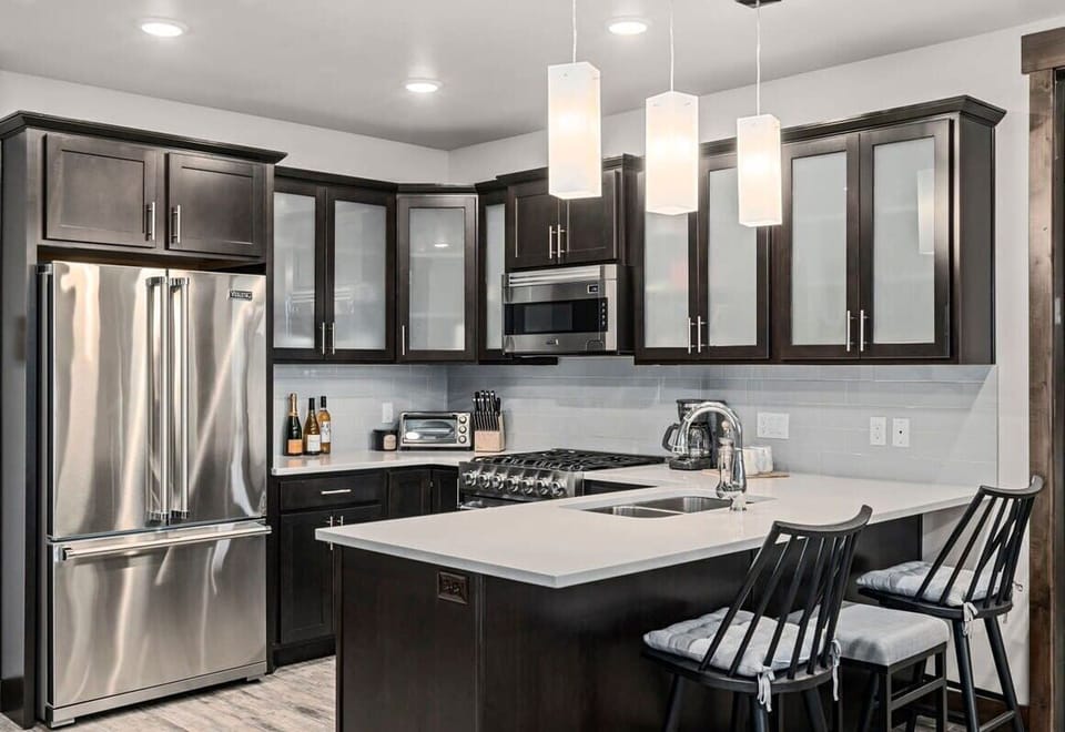 Fully stocked kitchen with Viking appliances and breakfast bar seating for 3
