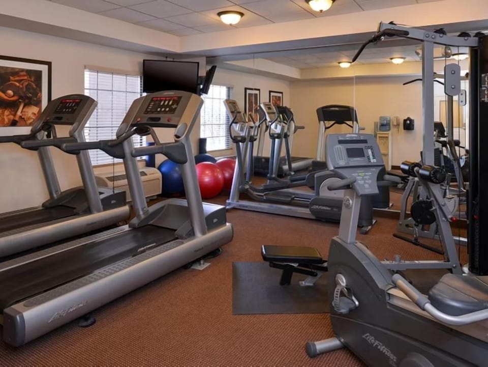 Fitness center with cardio machines and weights.