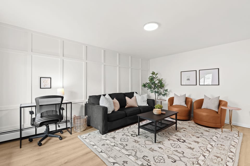 Bright, modern living room with work-from-home desk and plenty of cozy seating.