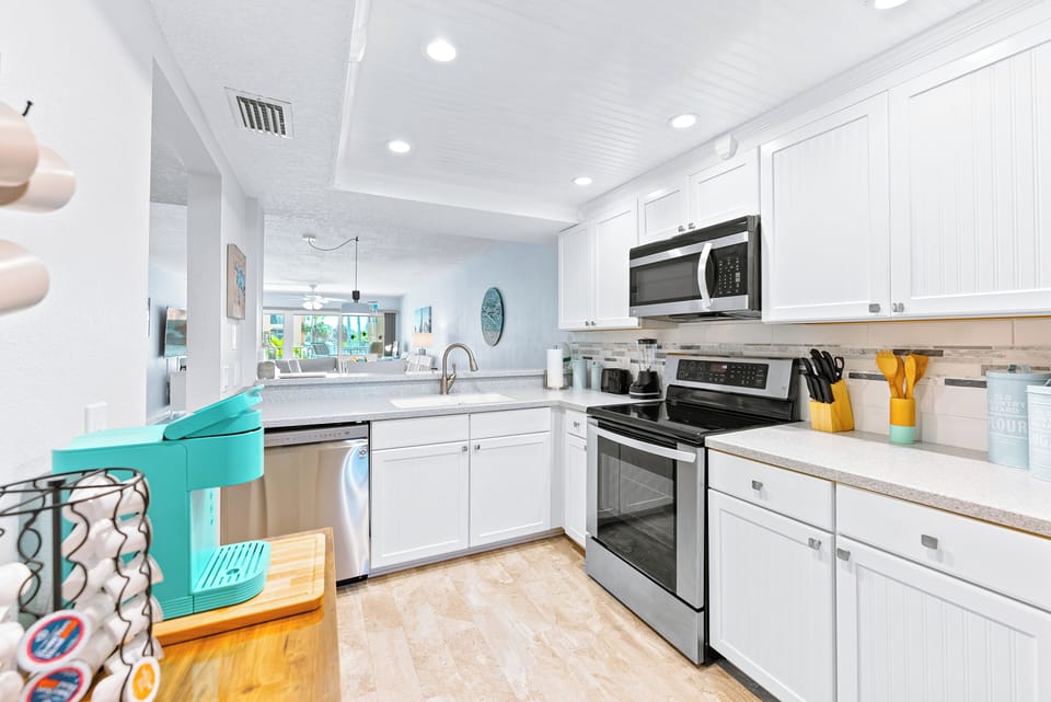 Spacious and modern white kitchen with coastal accents.