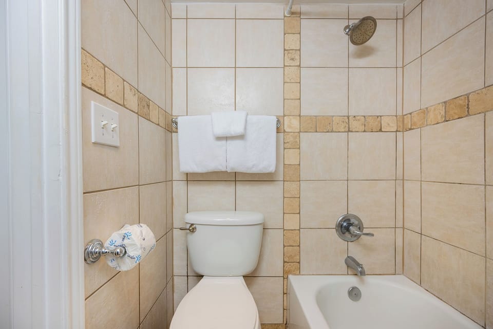 Step into the master bath where warm tile tones create a calm space to refresh after a day outdoors