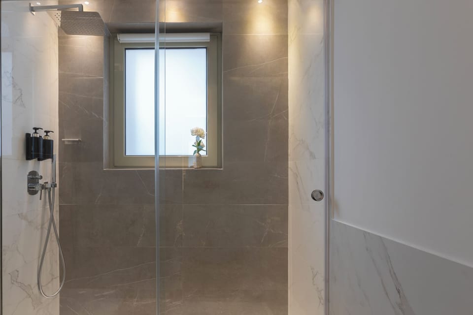 Designer toiletries, hair dryer, slippers, bidet
