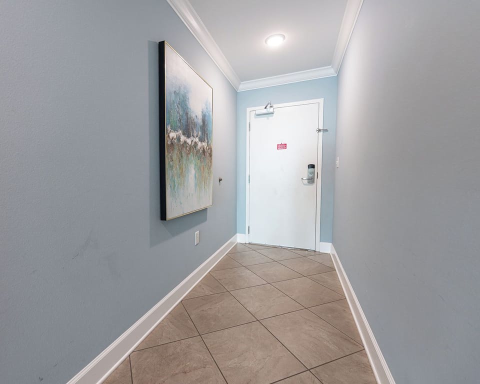Step into a serene entryway adorned with art, welcoming you to relax and explore your coastal retreat