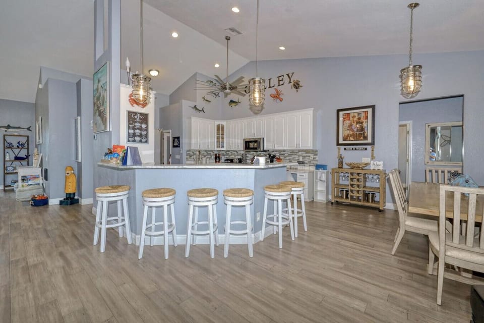 Bar stool seating for 6 at the kitchen counter. Dining table for 6 on right
