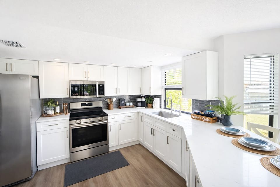 Bright modern kitchen with stainless steel appliances. Fully stocked.