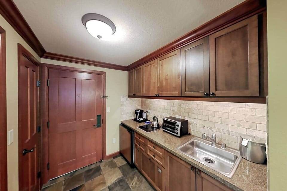 Trey's Kitchen with half-fridge, dishwasher, garbage disposal, toaster/oven, invection stove, coffee maker and coffee, plates, glasses, silverware, pots and pans, microwave, mixing bowls, cooking utinsels, and ice bucket