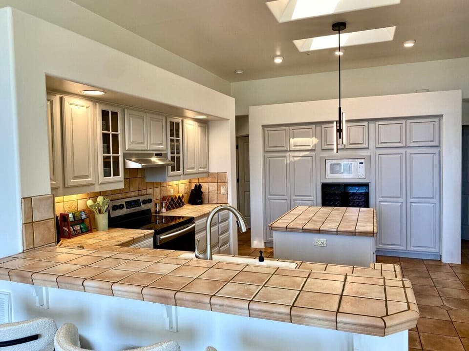 The spacious, well-stocked kitchen and open floor plan support social connection around food and celebration