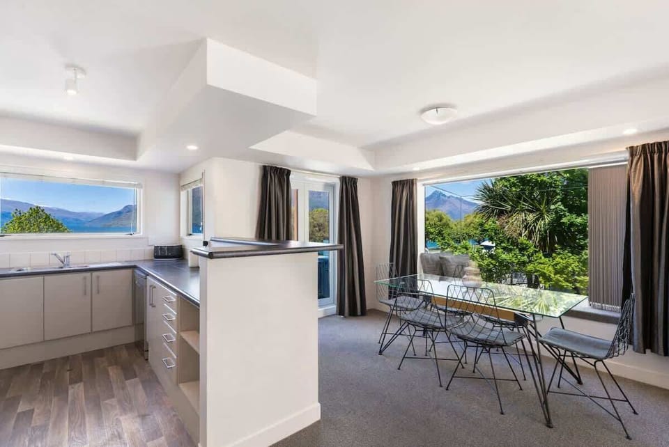Open flow kitchen and dining area, with incredible lake and mountain views, with access onto your private balcony.