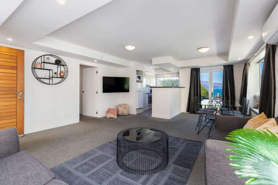 Entertainment lounge, with open flow dining area, kitchen and private balcony.