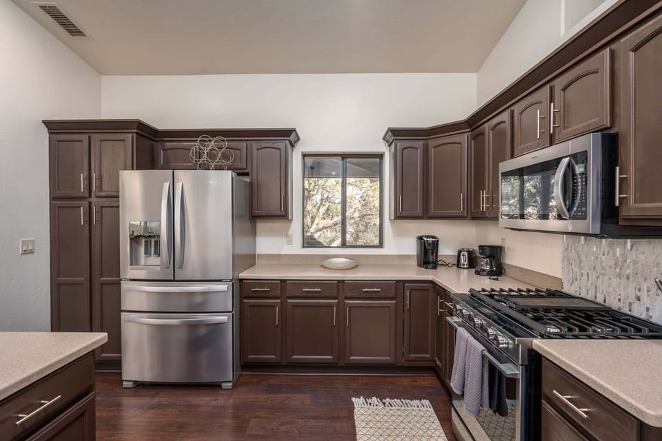 Cook, gather, and connect in this spacious chef's kitchen featuring stainless steel appliances and abundant prep space.