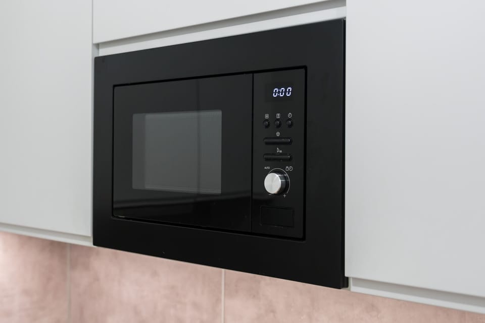 Modern microwave and kitchen setup, with high-quality appliances ensuring a stress-free cooking experience during your stay.
