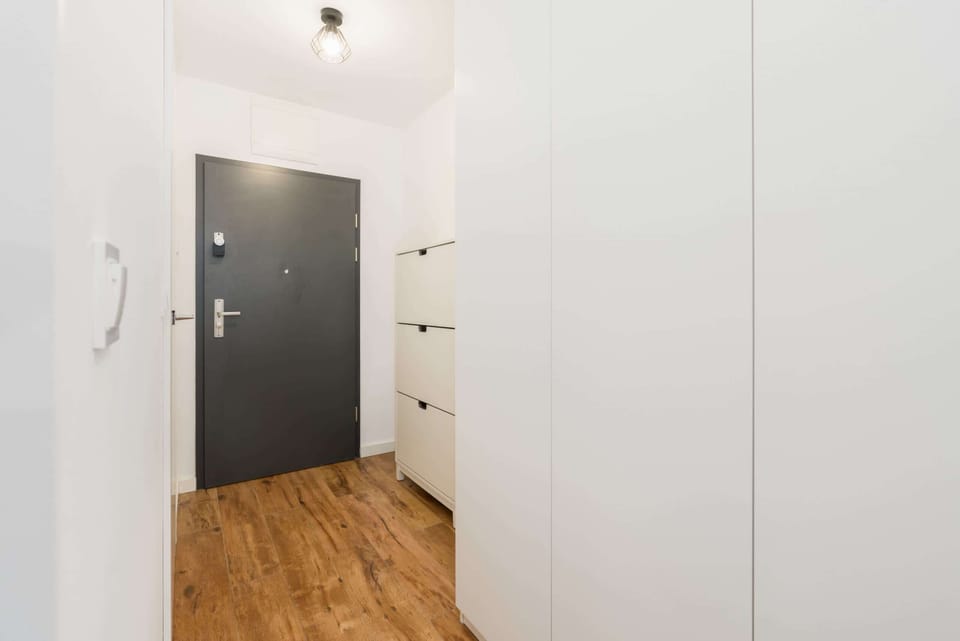 Stylish hallway and entryway, with functional storage and clean lines, offering a warm welcome as you enter the apartment.
