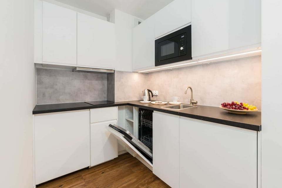 Another view of the kitchen, showcasing the kitchen's open layout with modern appliances, ideal for cooking and entertaining.
