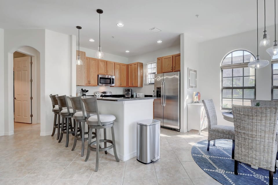 The Kitchen Has 4 Barstools and A Open Concept