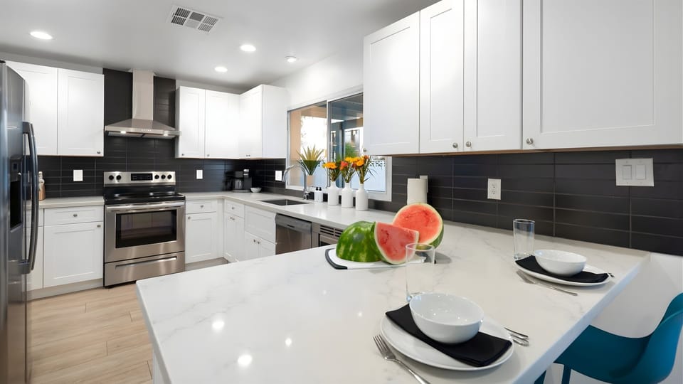 Admire the beautiful kitchen as you serve a casual breakfast at the counter