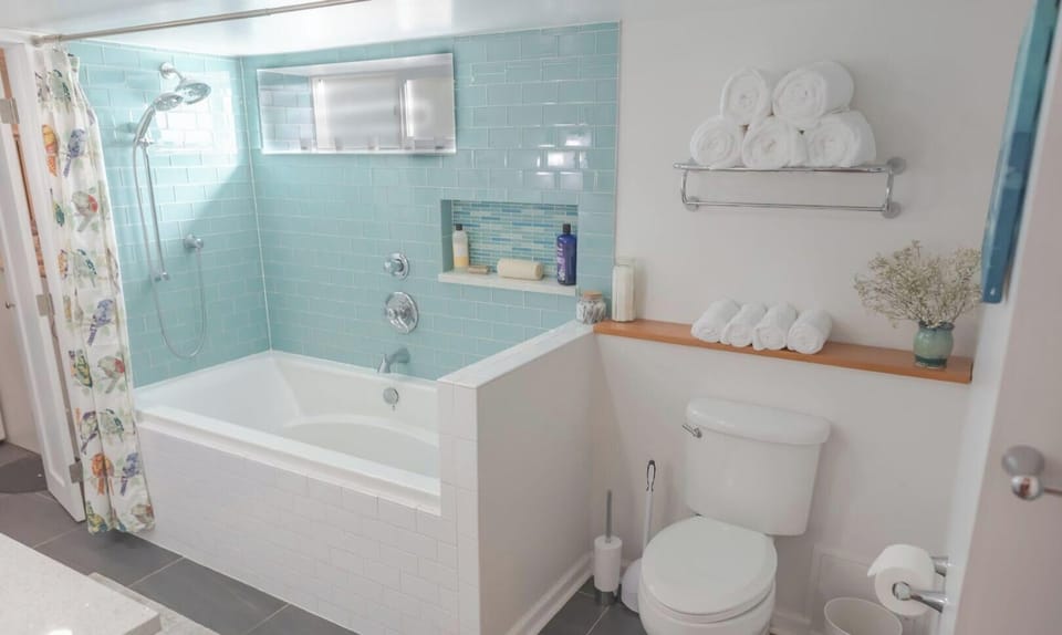 Clean bathroom with bathtub.