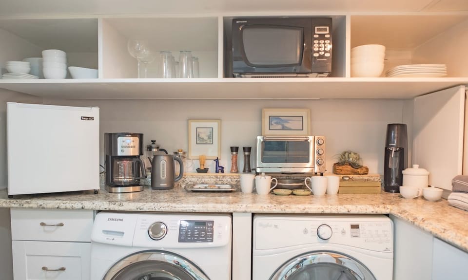 Functional kitchen and laundry area with modern appliances