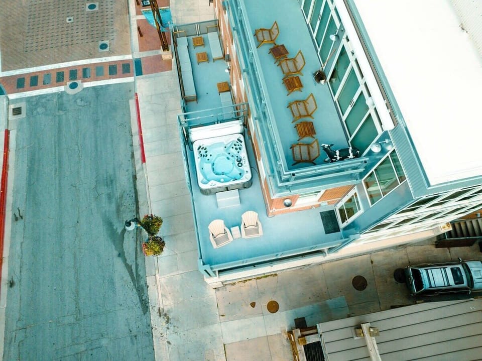 An aerial view of the beautiful patio with its two adirondack chairs and private, 4-person hot tub. It enjoys views of the mountains and Main Street.