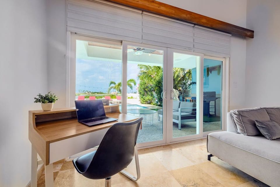 Catch up on work at your cozy desk, then step through the sliding doors to your private pool and lounge area, where tropical breezes and stunning views await.
