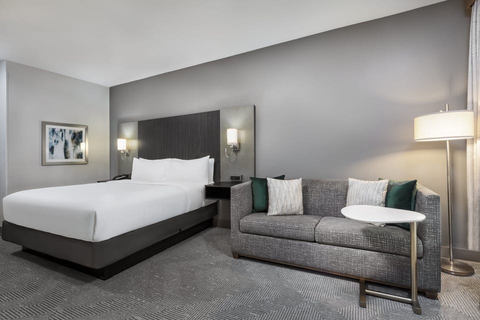 Premium bedding, desk, laptop workspace, iron/ironing board
