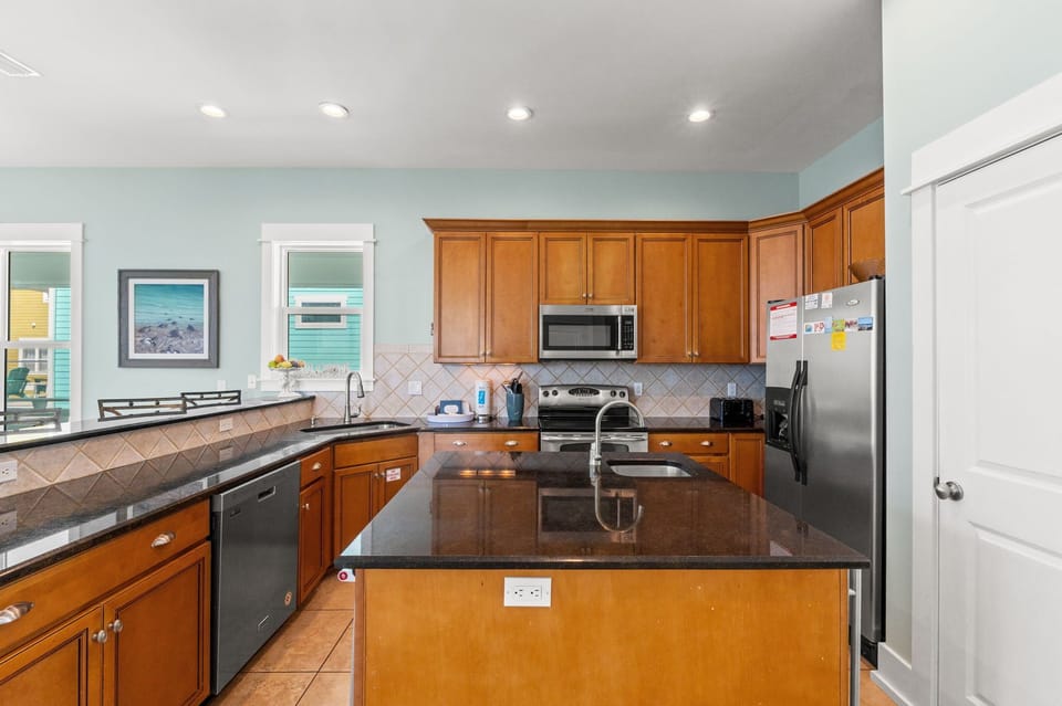 Your spacious kitchen awaits with granite counters, stainless appliances, and ocean views to inspire your culinary adventures.