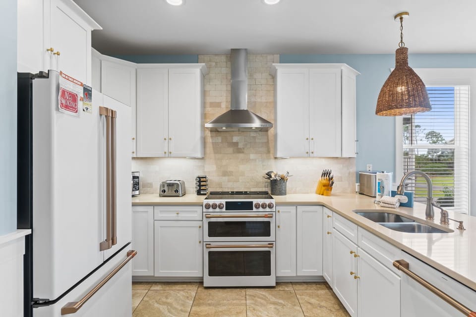 Gather around your fully equipped kitchen, where sleek countertops and modern appliances invite you to craft memorable meals together. Natural light streams in, warming the space as you cook.