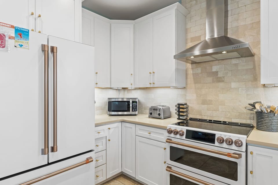 Cook your favorite meals in this well-equipped kitchen featuring modern stainless steel appliances, a gas range, and all the cookware you need for a home-away-from-home experience.